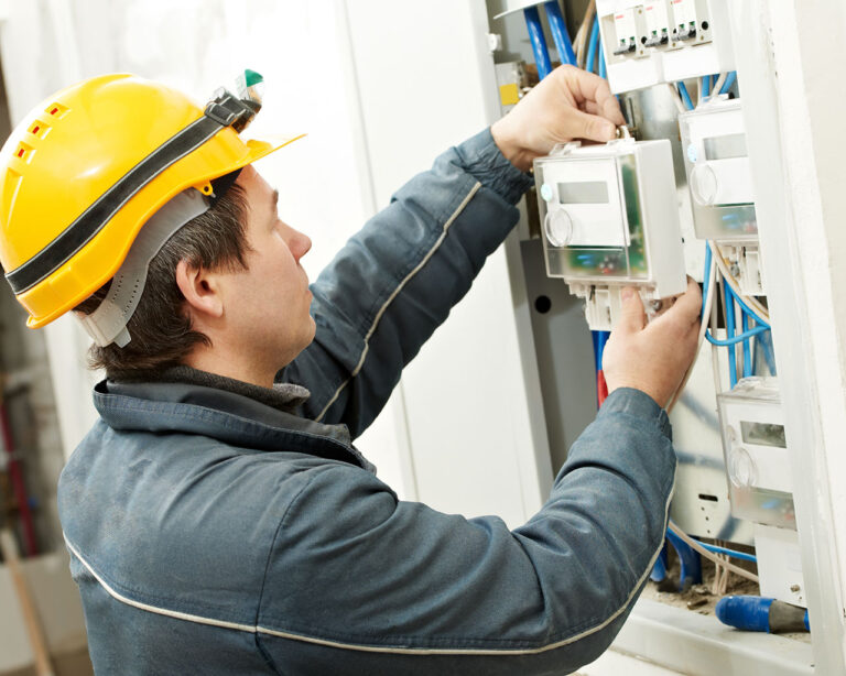 Worker installing energy meter